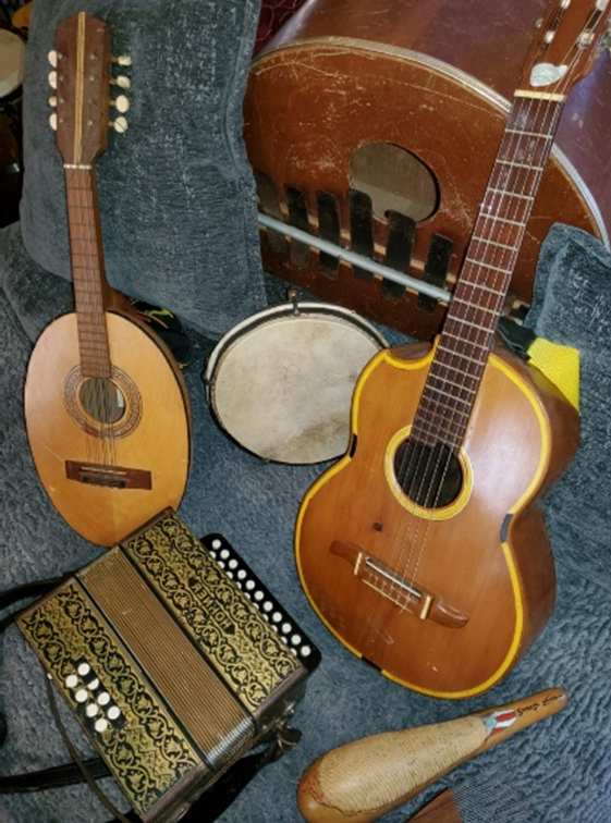Imagen de una guitarra, marímbola, pandero, mandurria, acordeón diatónico y güiro.